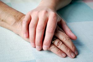 Close-up of two hands on the table with daylight.